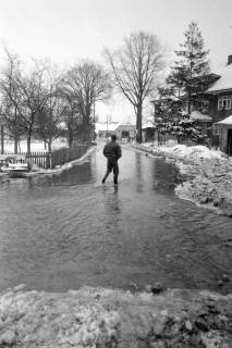 ARH NL Mellin 02-107/0012, Fußgänger auf einer überschwemmten Straße im Winter, um 1970