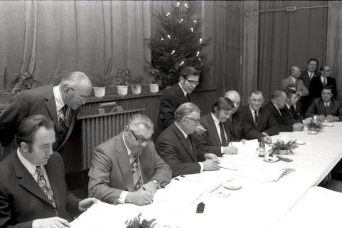 ARH NL Mellin 02-193/0007, Männer unterzeichnen Dokumente bei einer Versammlung, um 1970