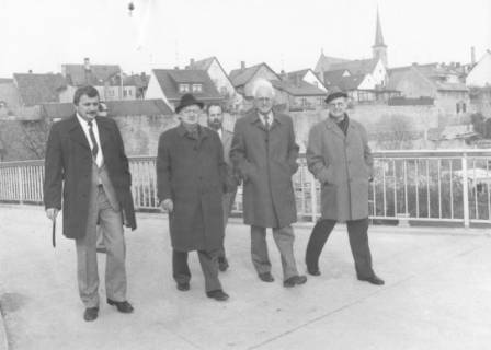 ARH Slg. Bartling 1324, Bürgermeister Henry Hahn und städtischer Angestellter Gerhard Bednarski aus Neustadt a. Rbge. überschreiten mit drei unbekannten Herren eine Brücke, im Hintergrund das Kloster (Karmelitenkirche), Bad Neustadt a. d. Saale, um 1980
