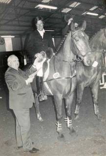 ARH Slg. Bartling 1403, Hallen-Reitturnier, Pferd mit Reiter bei der Siegerehrung und Überreichung eines Ehrentellers durch Bürgermeister Henry Hahn, Mandelsloh, um 1982