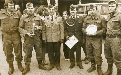 ARH Slg. Bartling 2286, Gruppe von vier Soldaten in Arbeitsuniform mit einen Pokal (links) bzw. einen Teller (rechts) sowie eine Urkunde für den Sieger im Vergleichsschießen der Reservistenkameradschaft, Neustadt a. Rbge., 1973