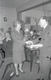 ARH Slg. Bartling 2369, Ein Mann schüttelt einer Dame die Hand nach Überreichung eines Blumenstraußes, DRK-Kreisverband, Neustadt a. Rbge., ohne Datum