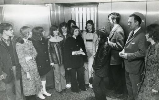 ARH Slg. Bartling 2727, Werbeleiter Rolf Hantelmann (3. v. r.) mit einer jugendlichen Besuchergruppe vor dem Gitter des Kellertresors in der neuen Kreissparkasse, Neustadt a. Rbge., 1972