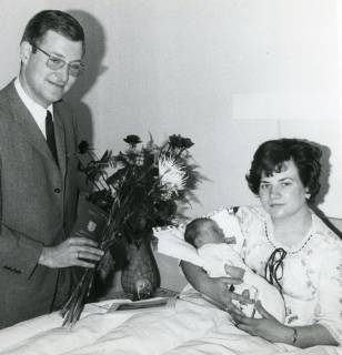 ARH Slg. Bartling 2753, Überreichung eines Blumengebindes an eine Frau mit Neugeborenem im Wochenbett durch Werbeleiter Rolf Hantelmann, Neustadt a. Rbge., 1969