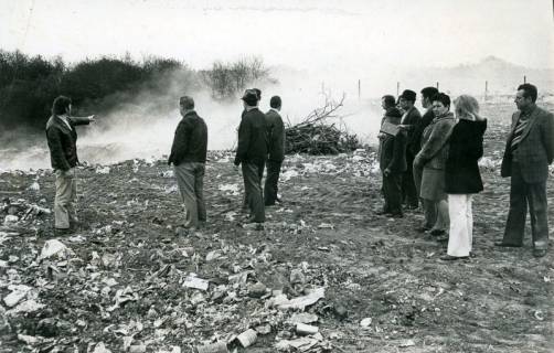 ARH Slg. Bartling 4910, Gruppe von Leuten auf der qualmenden Müllkippe, Scharrel, 1974