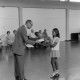 Archiv der Region Hannover, ARH NL Mellin 01-196/0016, Ehrung eines jungen Mädchens durch einen Herren in einer Sporthalle