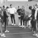 Stadtarchiv Neustadt a. Rbge., ARH Slg. Bartling 1956, Zwei Handball-Mannschaften auf dem Platz vor einer Turnhalle bei der Seitenwahl durch Münzwurf (?), Neustadt a. Rbge.